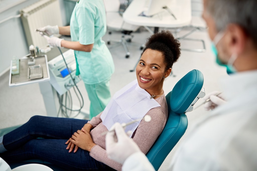 Happy Black Woman Talking to Her Dentist During Dental Exam