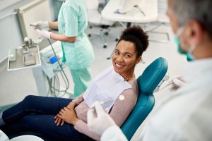 Happy Black Woman Talking to Her Dentist During Dental Exam
